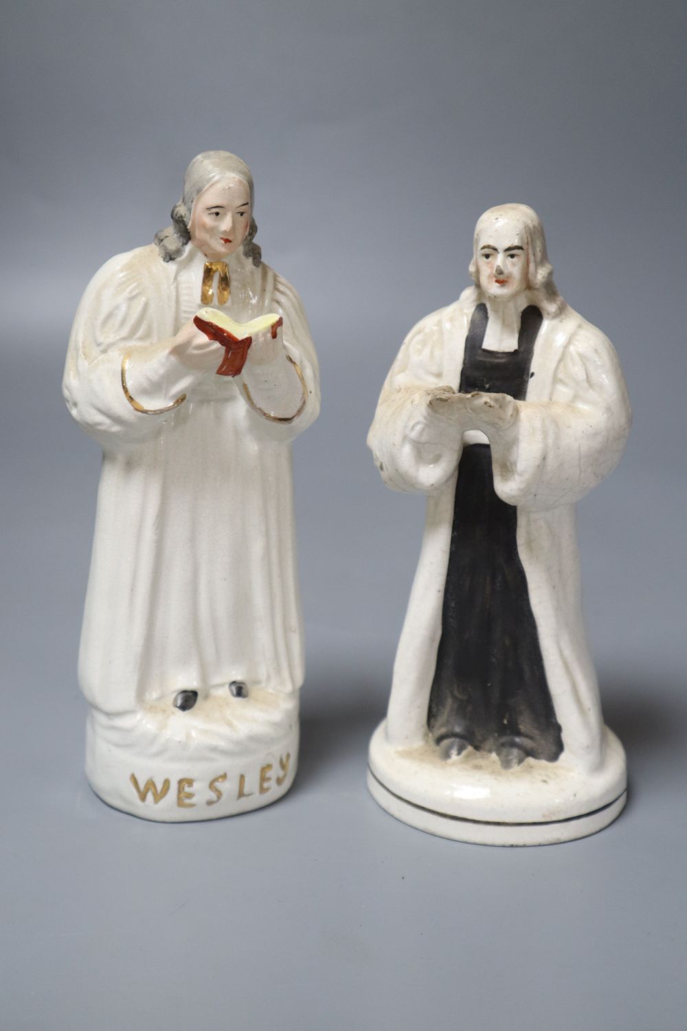 Two mid 19th century Staffordshire pottery figures of John Wesley (one a.f.)